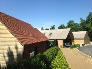 Pitched, tiled roof and sweet chestnut shake roofs completed by Kingsley Roofing at the open air museum in Chichester.