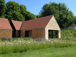 A building at the open air museum in Sussex recently completed by Kingsley Roofing in red tiles on a pitched roof